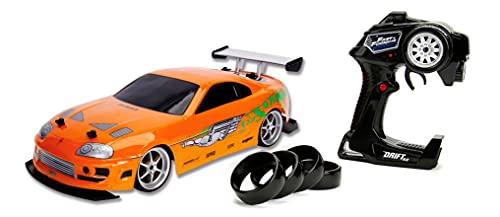 Jada Toys Fast & Furious RC Auto Drift 1995 Toyota Supra Turbo-Coche teledirigido con 2 Canales, función de Carga USB, 4 neumáticos de Repuesto, Incluye Pilas, 1:10, Color Naranja (253209003)